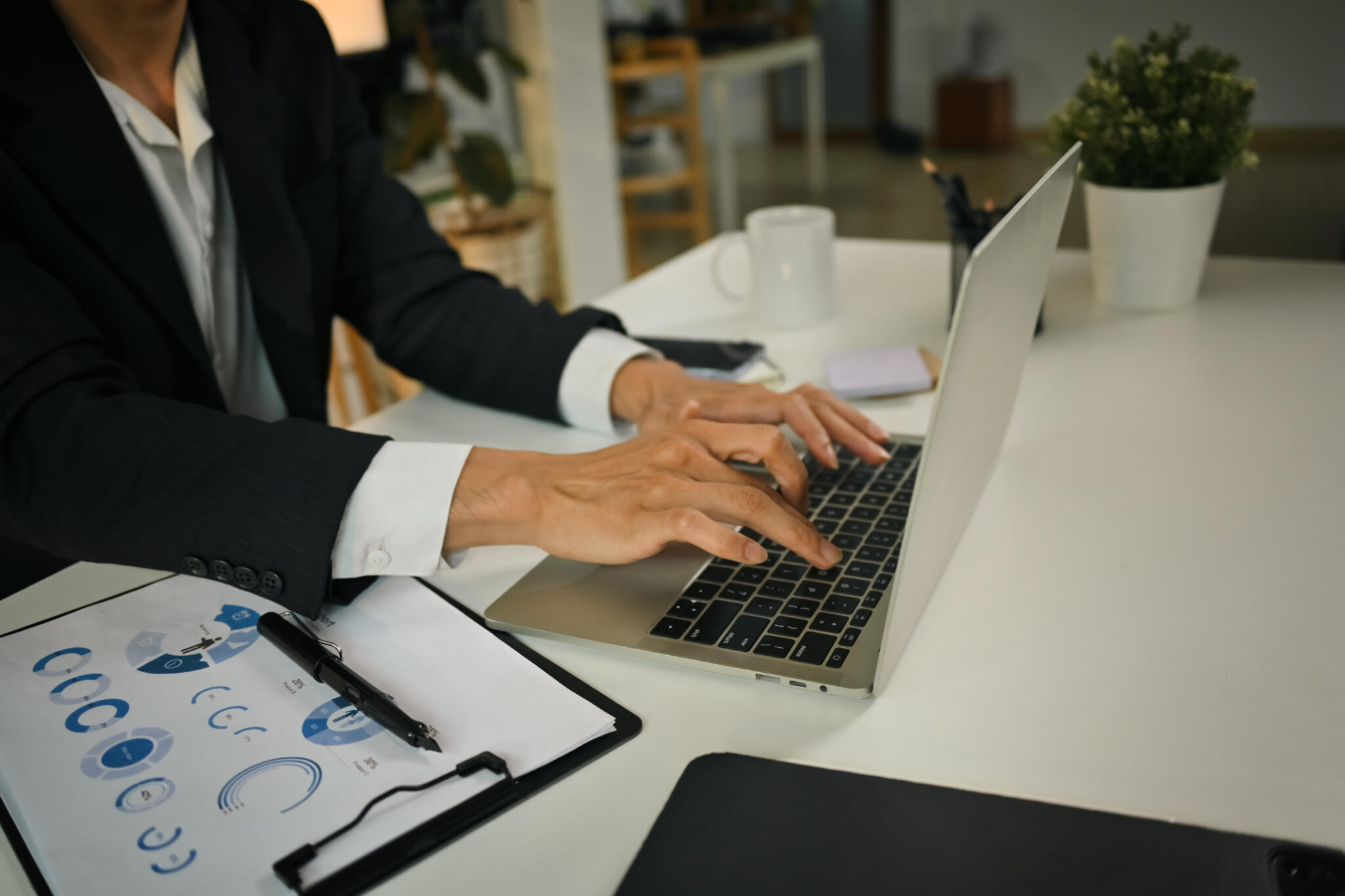 Businessman hands typing on laptop keyboard, checking financial